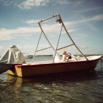 person riding white motorboat