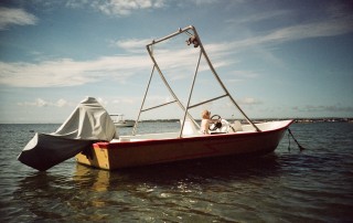 person riding white motorboat