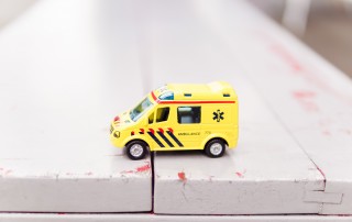 yellow car toy on white surface