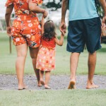 man and woman holding their daughter