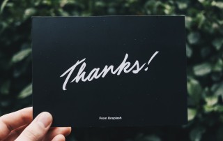 person holding Thanks card